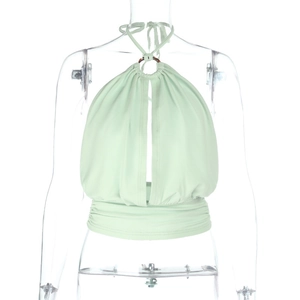 Close-up of mint green halter top featuring a metal ring connector and ruched hem detail