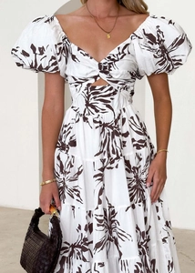 Detail of white summer dress with puff sleeves and unique cutout bust design