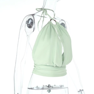 Detail of mint green halter top featuring chest cutout and tortoiseshell ring connector