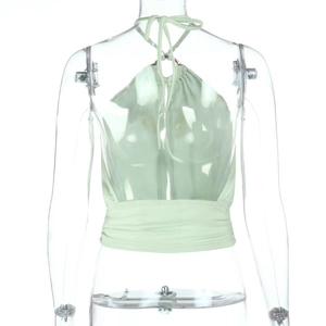 Detail of mint green halter neck top featuring gathered waist and open back design