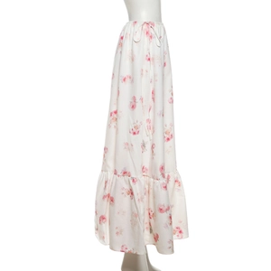 Close-up of cream floral skirt featuring pink rose patterns and tiered ruffle hem details