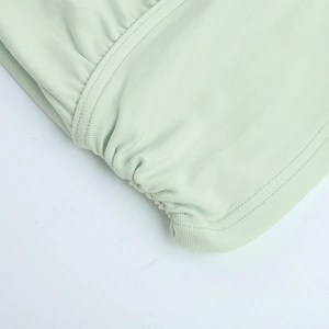 Detail of mint green ribbed knit fabric showing fine stitching and soft texture