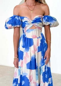 Detail view of the elegant cutout waist and puff sleeves on a floral A-line dress