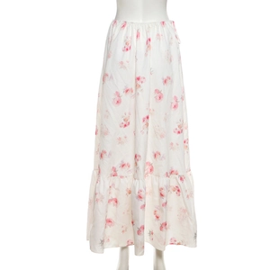 Detail of floral printed white dress showing elastic waist and ruffled hem texture