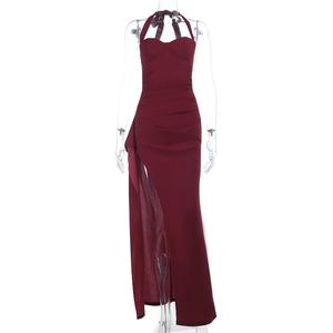 Close-up of the burgundy evening dress featuring high slit and pleated waist details