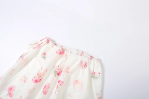 Detail view of elastic waist and pink rose floral pattern on breathable chiffon skirt