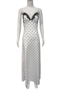 White polka dot midi sleepwear dress with black lace V-neckline on a mannequin