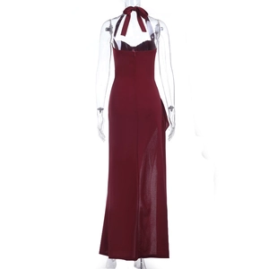 Detail of burgundy backless evening dress featuring large bow tie and shimmering fabric