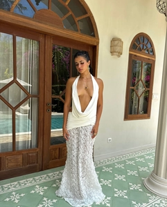 Detailed macro view of intricate 3D rose lace pattern on white slim-fit dress