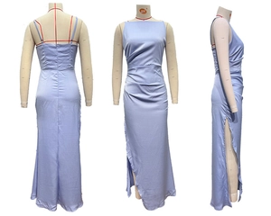 Detail view of light blue satin dress featuring side ruched texture and high leg slit design