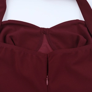 Close-up of heart-shaped neckline and hidden zipper on burgundy party dress