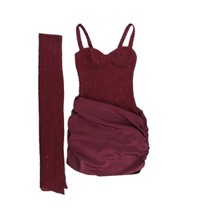 Detail of wine red mini dress featuring sequined bodice and satin skirt with matching scarf