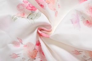 Macro detail of soft ivory woven fabric with elegant pink rose floral print textures