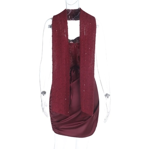 Detail of wine red two-piece dress with sequined lace top and ruched satin mini skirt