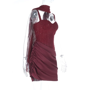 Detail of burgundy tube dress featuring sequined lace bodice and satin ruched skirt texture