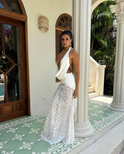 Detail of white two-piece set featuring backless halter top and 3D rose texture long skirt