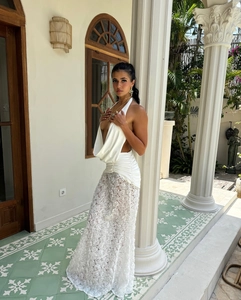 Detail of white halter neck satin top with 3D floral lace long skirt for summer style