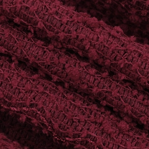 Macro shot of the wine red textured knit fabric with premium glitter bow details
