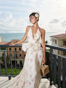Elegant white floral halter maxi dress with bow detail and tiered ruffles for summer