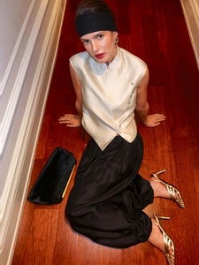 Elegant beige satin sleeveless blouse with a stand collar and high-waist black trousers