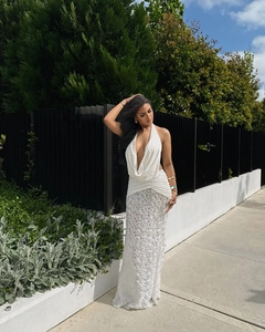 Detail of elegant white halter neck dress with intricate 3D rose textured floral pattern
