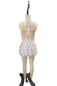 Detail view of backless polka dot dress with halter neck and ruffled layers