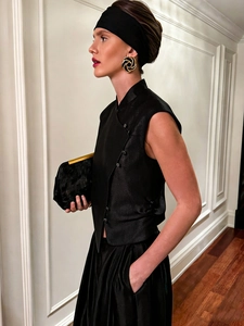 Elegant sleeveless black mandarin collar top and satin skirt in minimalist fashion style