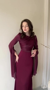 Detail of elegant pleated bodice and flowing split sleeves on a burgundy slim fit maxi dress