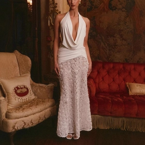 Close-up of white halter-neck dress featuring intricate 3D rose appliqué details