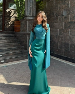 Detail of teal evening gown with draped cape sleeves and pleated bodice design