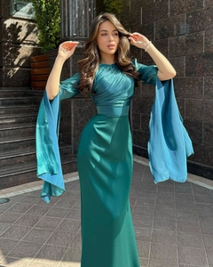 Detail of elegant emerald green evening gown with dramatic slit flared sleeves and satin texture