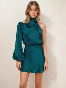 Detail of elegant emerald green satin one-shoulder dress with long puff sleeve