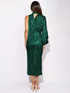 Close-up of emerald green sequin dress showing unique one-shoulder and cape design detail