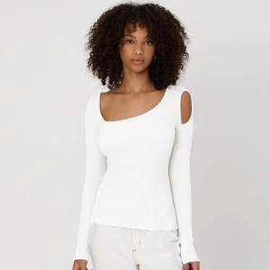 Close-up of white ribbed knit top featuring asymmetrical neckline and shoulder cut-out