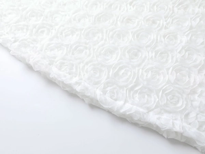 Detail of white 3D floral lace fabric with 3D roses for elegant summer dresses