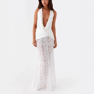 Detail of white backless dress featuring 3D rose embroidery and sheer lace texture