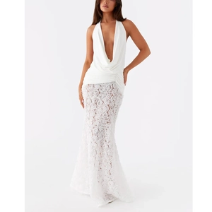 Detailed view of white backless dress with 3D rose flower applique and fishtail hemline