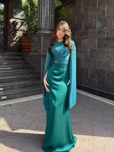 Elegant emerald green slim fit floor-length evening gown with unique cape sleeve design