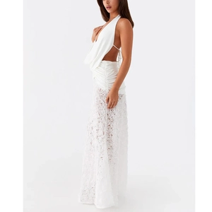 Detail of white lace dress with 3D rose patterns and backless halter neck design