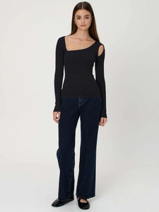 Detail of black rib-knit top with asymmetrical cut-out shoulder and long sleeves