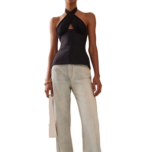 Detail shot of black halter criss-cross top with textured fabric and open back design