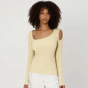Close-up of cream ribbed knit top with asymmetric neckline and shoulder cutout detail