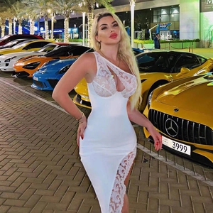 Detail of white one-shoulder bodycon dress with lace trim and mesh inserts
