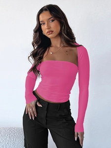 Slim fit pink tube top and long sleeve shrug set paired with high waist black cargo pants