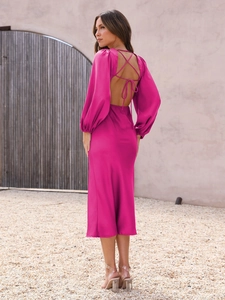 Detail of fuchsia satin midi dress showing open back design and cross-strap tie feature