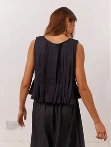 Detailed back view of an elegant black sleeveless linen top with fine vertical pleats
