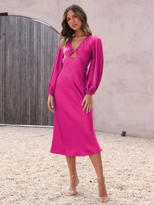 Detail of fuchsia satin dress showing lantern sleeves and waist cutout design