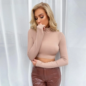 Detail of the ribbed knit fabric and high neck on a slim-fit crop long sleeve top