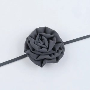Detail of elegant dark grey fabric rose choker with delicate layered chiffon petals