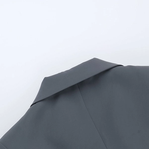 Detailed macro view of the grey notched lapel and fine fabric on a commuter blazer